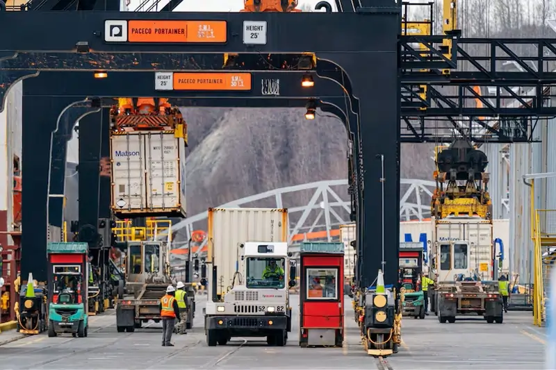 Alaska port with containers and trucks, illustrating the final mile delivery challenge that affects retail supply chains