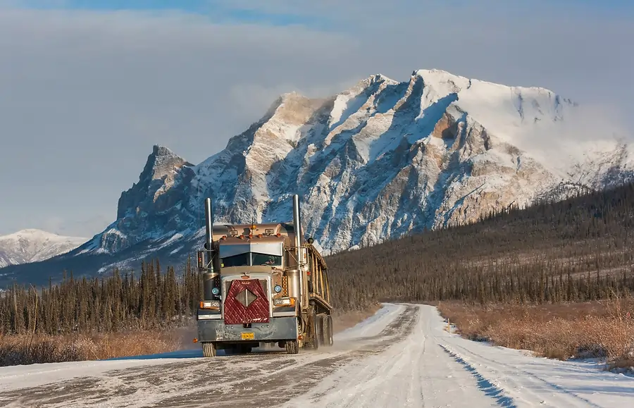 Truck navigating snowy Alaska road